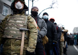 People wear masks as they attend a rally held by supporters of EU integration in Kiev